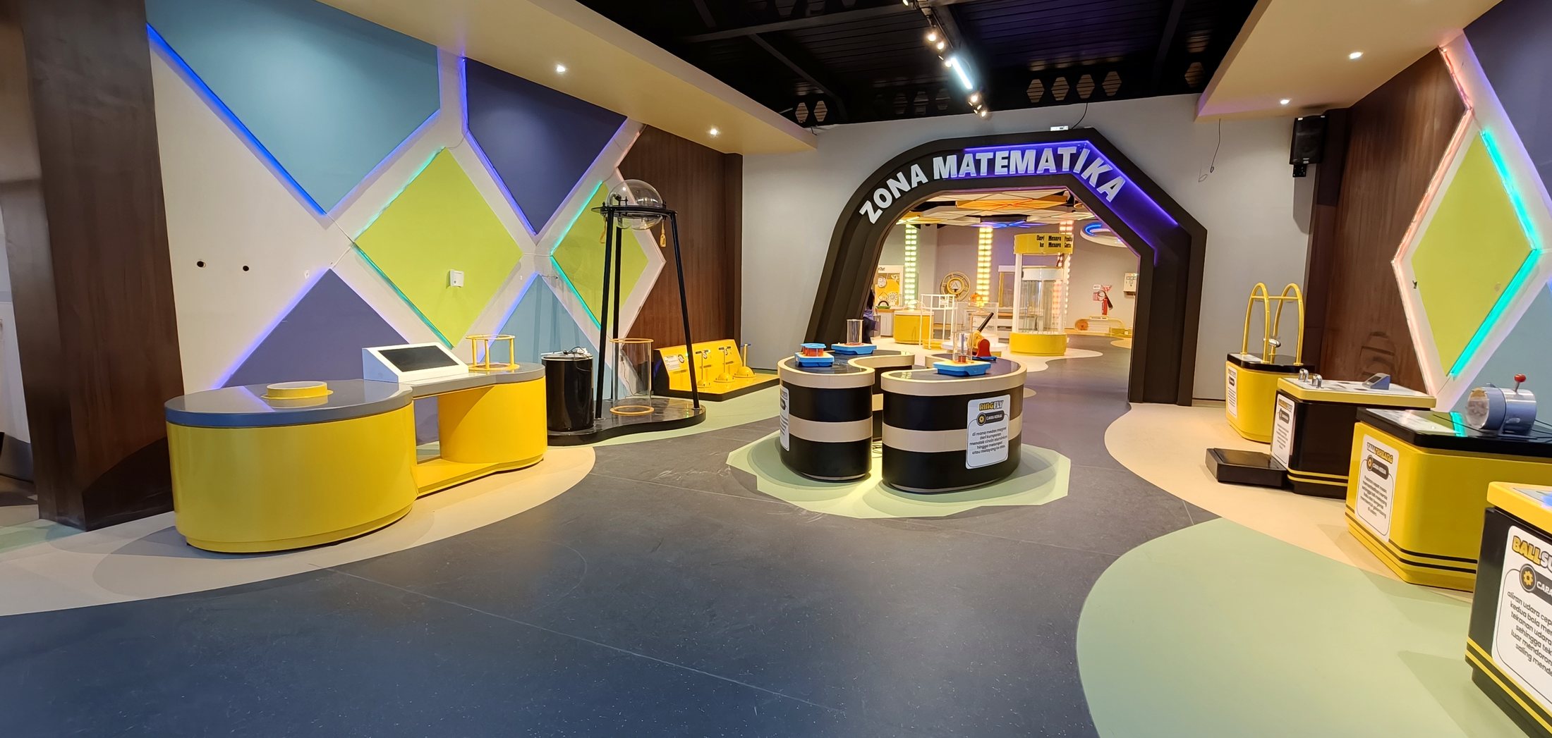 A finished gallery at MMSC with visitors walking through a curved installation